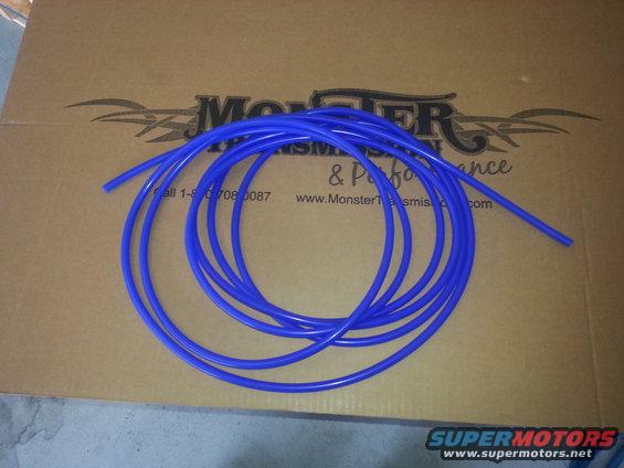 Blue tubing coiled on a cardboard box with "Monster Transmission & Performance" logo and website