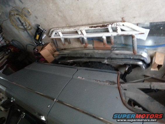 Car body panels and roof rack parts stored in a garage