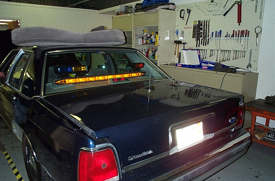 1991 Ford Crown Victoria LTD rear view with emergency lights and roof cushion
