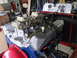 1967 Ford Mustang - Engine on a test stand with dual carburetors, radiator, and gauges. "LE MANS" valve cover is visible.