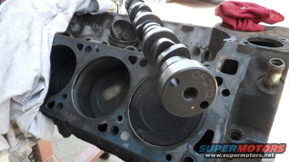 Engine block with camshaft installed. Camshaft has 'CR273' written on it