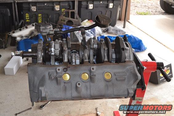 Engine block on red stand with oil pump pickup tube attached