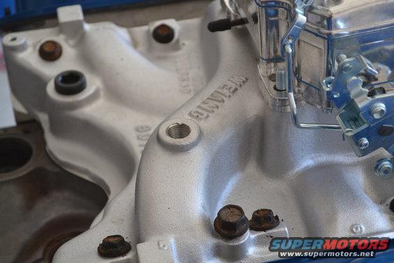 Close-up of a Weiand intake manifold with a carburetor attached