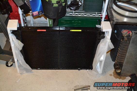 New black radiator in packaging, next to an old radiator