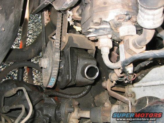 Close-up of a power steering pump and drive belt assembly