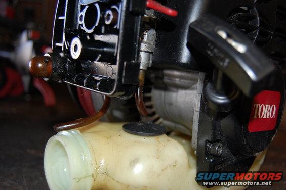 Toro engine fuel line connected to a translucent fuel tank