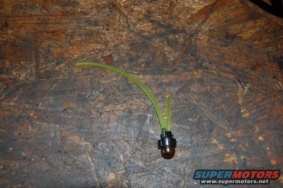 Fuel line with a primer bulb assembly on a wooden surface