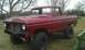 1978 Ford Bronco - This red 1978 Ford Bronco is shown in a three-quarter front view, missing its grille and with a lifted suspension.