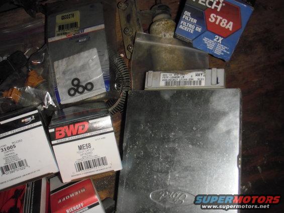 Assorted auto parts: oil filter, fuel injectors, and ECUs