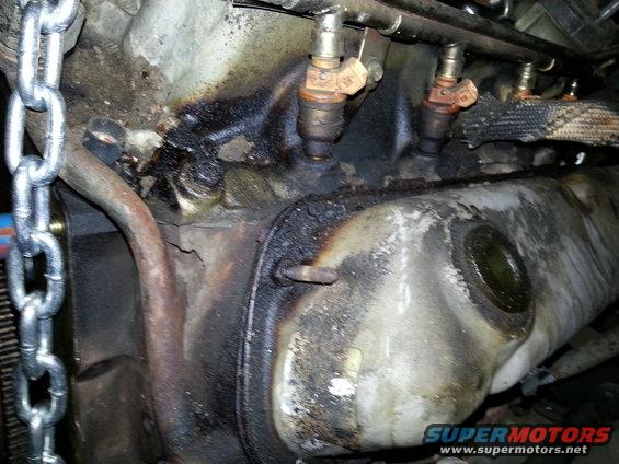 Close-up of engine fuel injectors and associated grime