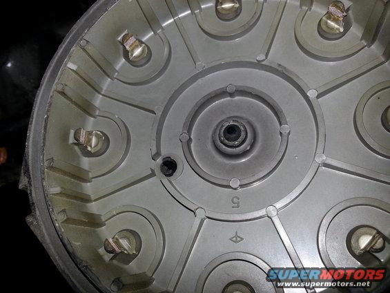 Distributor cap with metal terminals and plastic housing, showing a number 5