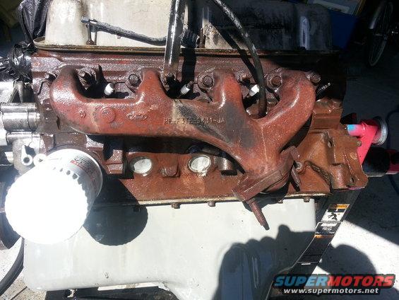 Close-up of a rusty Ford engine with an oil filter attached