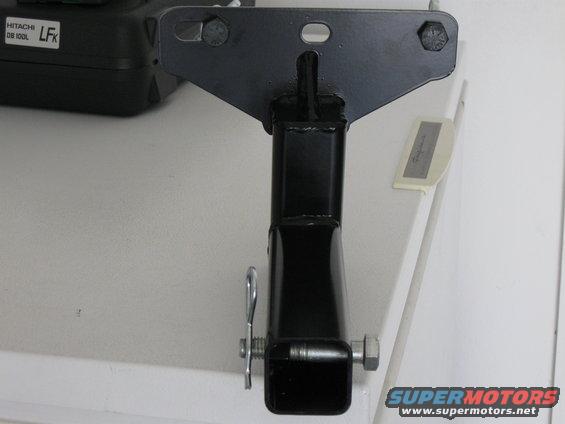 Black metal hitch receiver part with pin and bolt