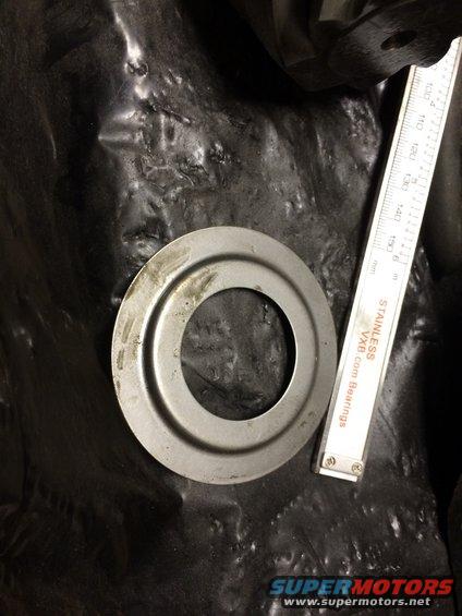 Metal ring next to a ruler showing measurements in mm and inches