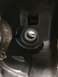 1996 Ford Bronco - Close-up of a black engine component with visible machining marks and a threaded bolt.