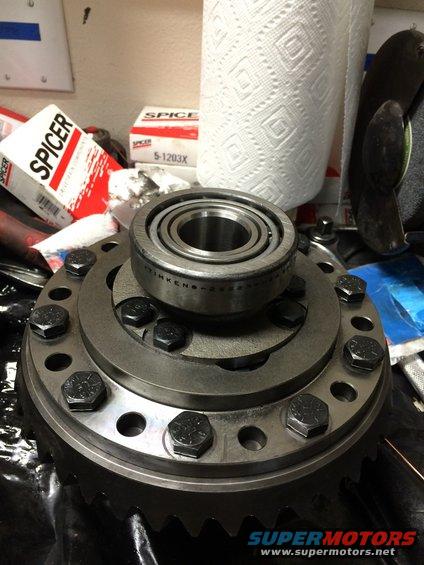 Differential carrier with bearing and bolts, with Spicer boxes and paper towels in background
