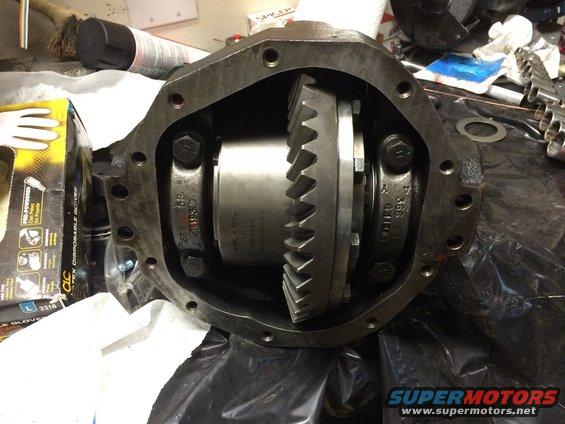 Differential housing with gears and bolts, showing internal components