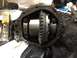 1996 Ford Bronco - Close-up view of a differential housing, revealing the ring gear and pinion assembly, with visible part numbers stamped on the components.