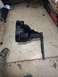 1996 Ford Bronco - A black metal vise with a handle is shown on a concrete floor, with a box for a vise in the background.