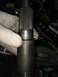 1996 Ford Bronco - A gloved hand holds a splined shaft, showing a retaining ring and some stamped markings.