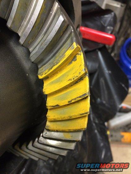 Close-up of a differential gear with yellow paint on the teeth