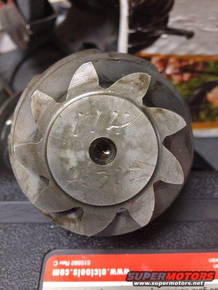 Close-up of a metal gear part with visible markings