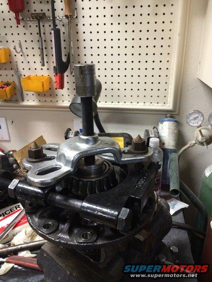 Bearing puller on differential housing with visible text 'SPICER'