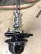 1996 Ford Bronco - A differential gear assembly is shown with a puller tool attached, resting on a workshop floor.