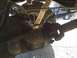 1996 Ford Bronco - Underside view of a vehicle's rear axle, driveshaft, leaf springs, and shock absorber. Another vehicle is visible in the background.