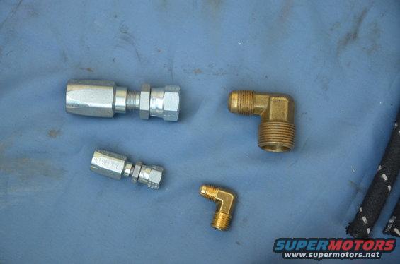 Hydraulic fittings and brass elbows on blue surface