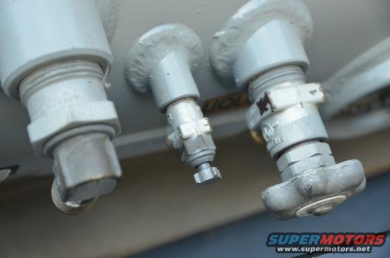 Close-up of three silver propane tank valves