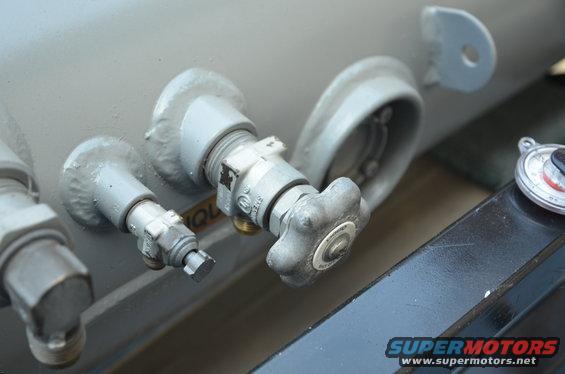 Close-up of propane tank valves and a pressure gauge