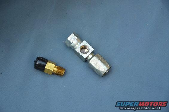 two metal fittings, one with a black cap