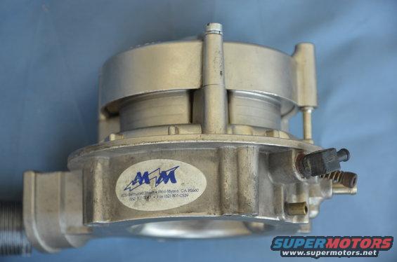 Aluminum carburetor with MM logo and address text