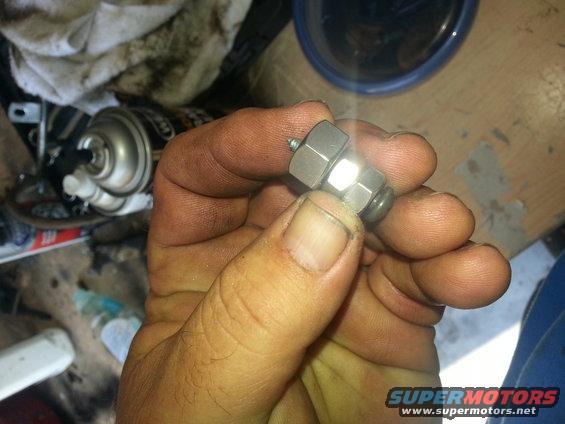 Metal fitting held in a dirty hand