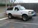 1996 Ford Bronco - This 1996 Ford Bronco is shown from a three-quarter front angle, highlighting its distinctive grille and two-tone paint scheme.