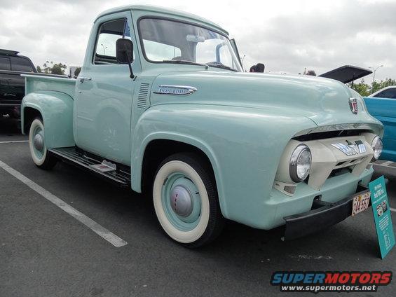 Light blue classic Ford F-100 pickup truck parked, front quarter view