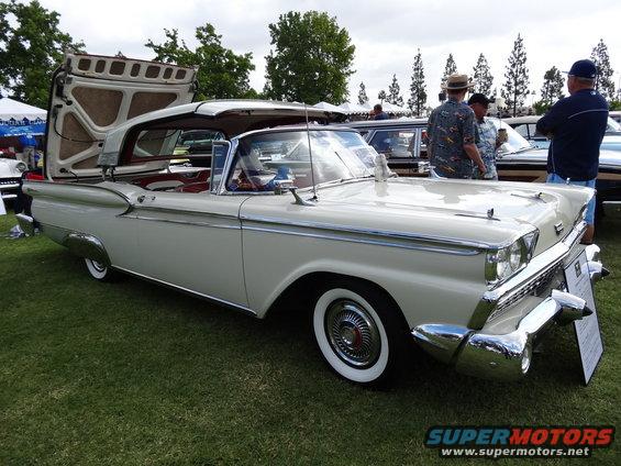 Cream 1959 Ford Fairlane 500 Skyliner with its hardtop roof raised, parked on grass
