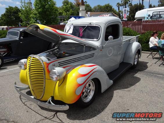 Gray pickup truck with flame graphics, hood open