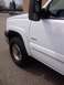 2006 Chevrolet Silverado 2500 - Front quarter view of a white 2006 Chevrolet Silverado 2500 pickup truck, highlighting its fender and door.