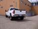 2006 Chevrolet Silverado 2500 - Rear view of a white 2006 Chevrolet Silverado 2500 pickup truck parked in a lot next to a brick building.
