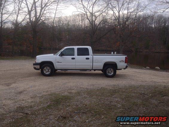 White 2006 Chevrolet Silverado 2500 pickup truck parked on dirt lot