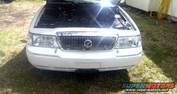 Front view of a white 2000 Mercury Grand Marquis with hood open