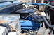 1981 Ford F-250 - The engine bay of a blue 1981 Ford F-250 shows a black air cleaner and blue valve covers.