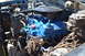 1981 Ford F-250 - Close-up of a blue engine in an engine bay, showing various components and wiring.
