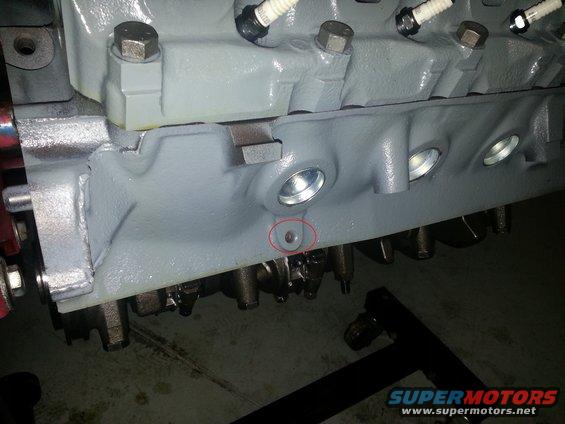 Close-up of a gray engine block with spark plugs visible