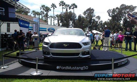 Silver Ford Mustang on display with #FordMustang50 hashtag and "2015 MUSTANG" text