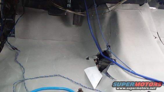 Vehicle interior with gray soundproofing material and blue wires