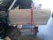 1996 Ford Mustang - Car door is prepped for paint and mounted on a stand for work.