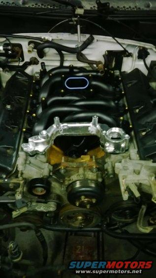 Engine bay with black intake manifold and silver bracket